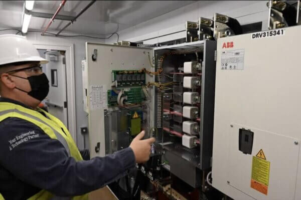 engineers reviewing panel for control systems integration