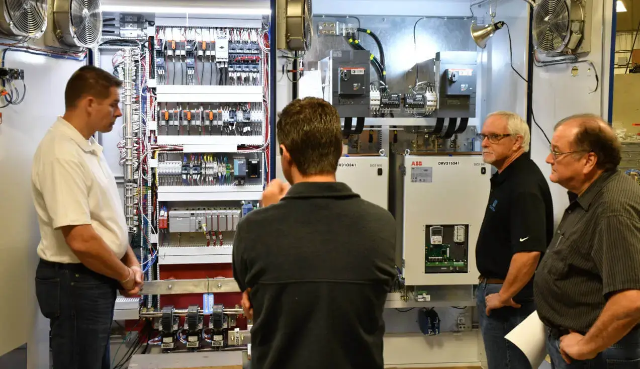 engineers inspecting control panels for system operations