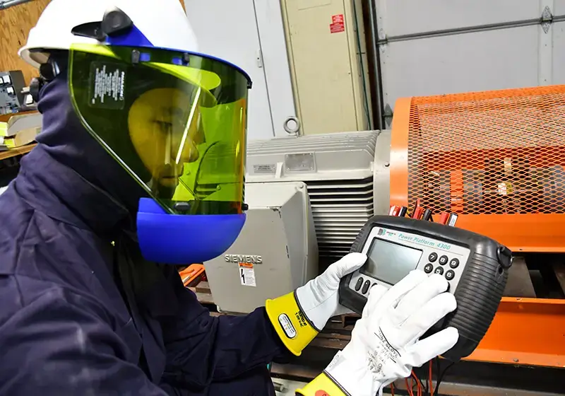 electric-company-demand-charges engineer testing equipment to help reduce demand charges