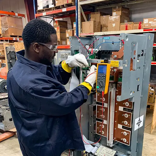 technician performing vfd troubleshooting on equipment