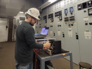 medium voltage power distribution engineer performing protective relay testing