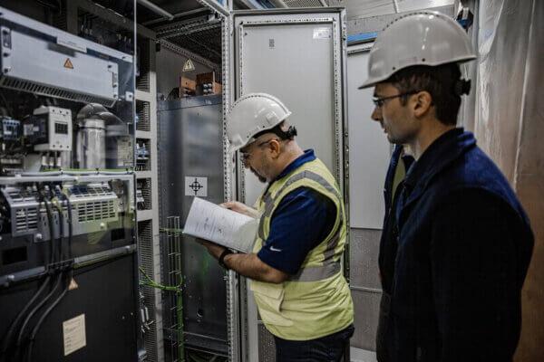 technicians reviewing electrical cable testing standards