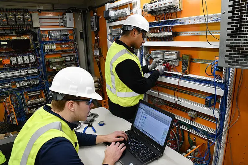 working on electrical systems during commissioning services