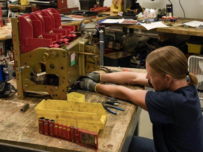 investigating-circuit-breaker technician performing circuit breaker reconditioning