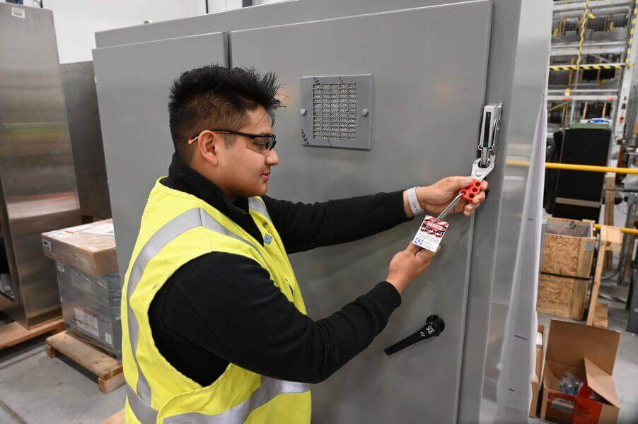 technician applying lockout tagout for safety compliance