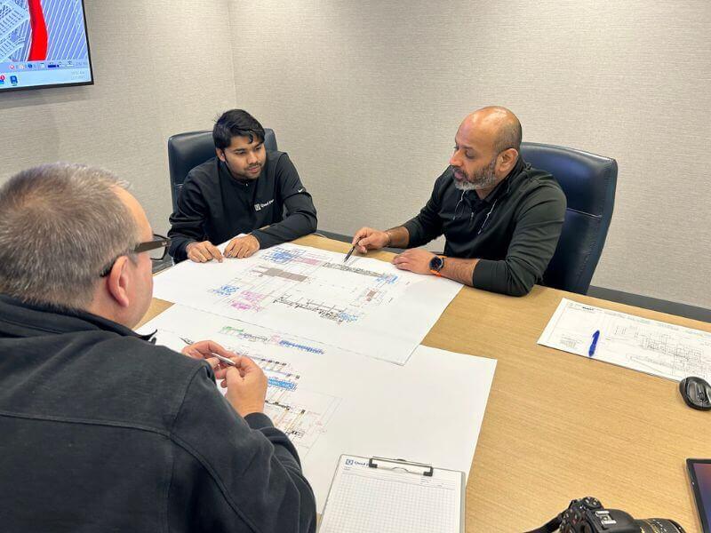 reviewing plans at a professional engineering company office