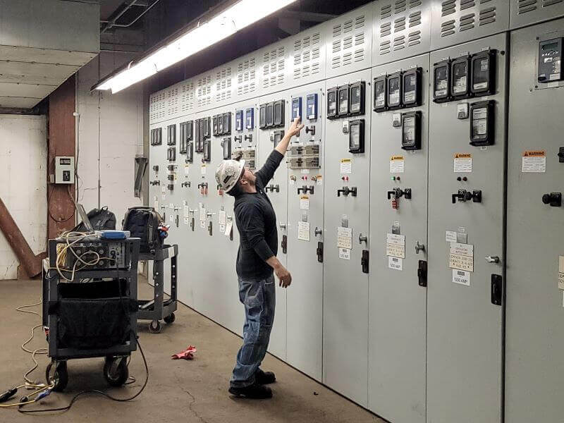 technician performing protective relay testing procedure