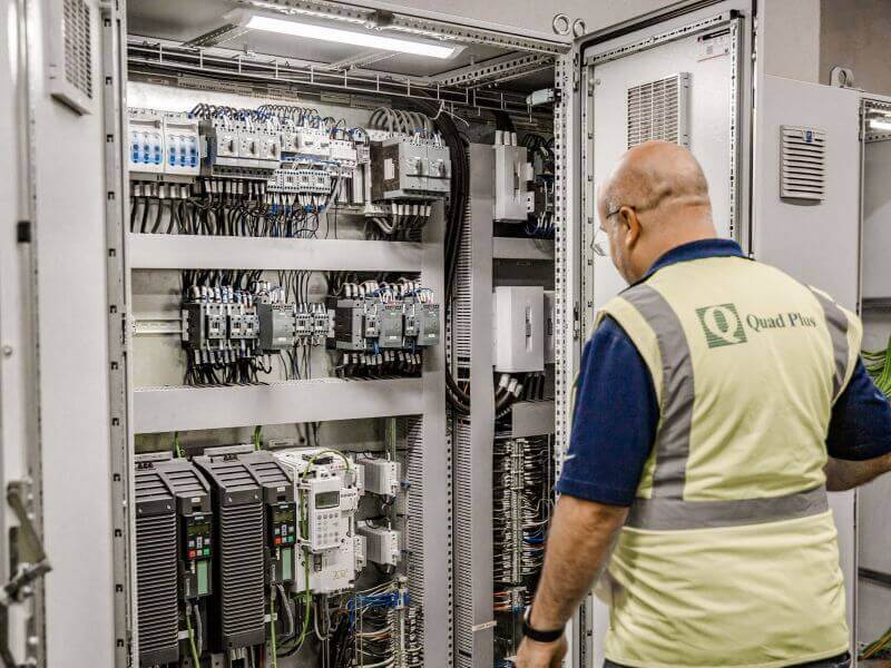 engineer inspecting control panel