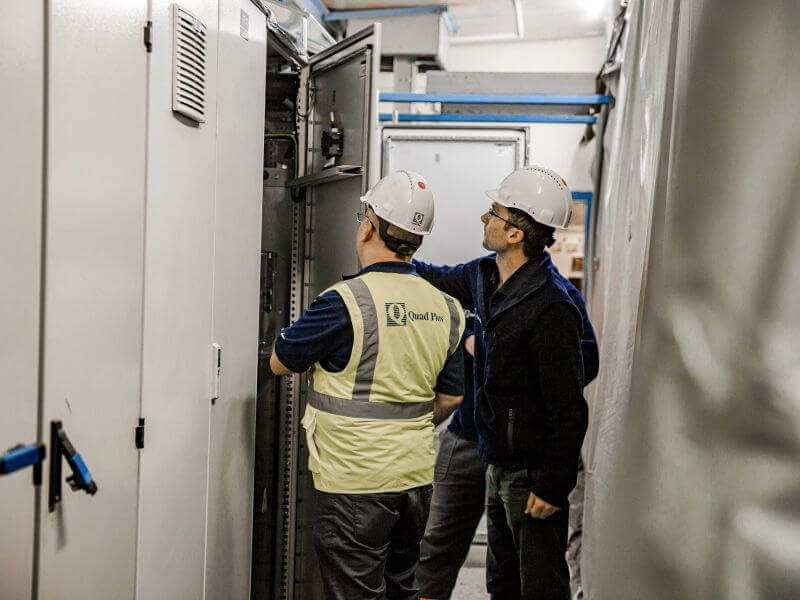 engineers inspecting electrical cabinet