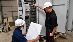 engineers reviewing converting machine schematics onsite