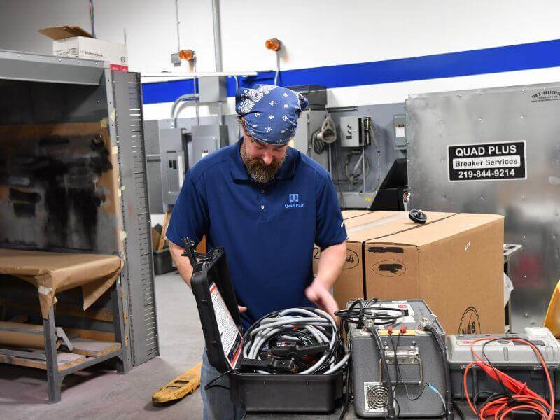 technician performing switchgear maintenance testing