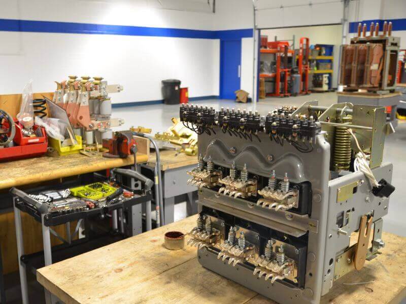 switchgear maintenance tools and parts on workbench
