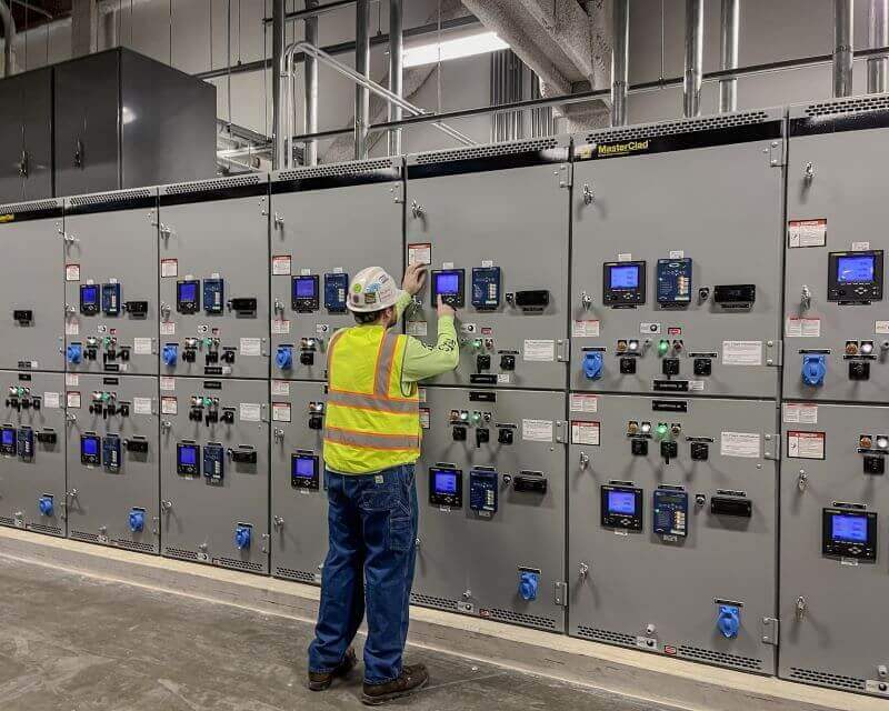 technician performing switchgear services in control room