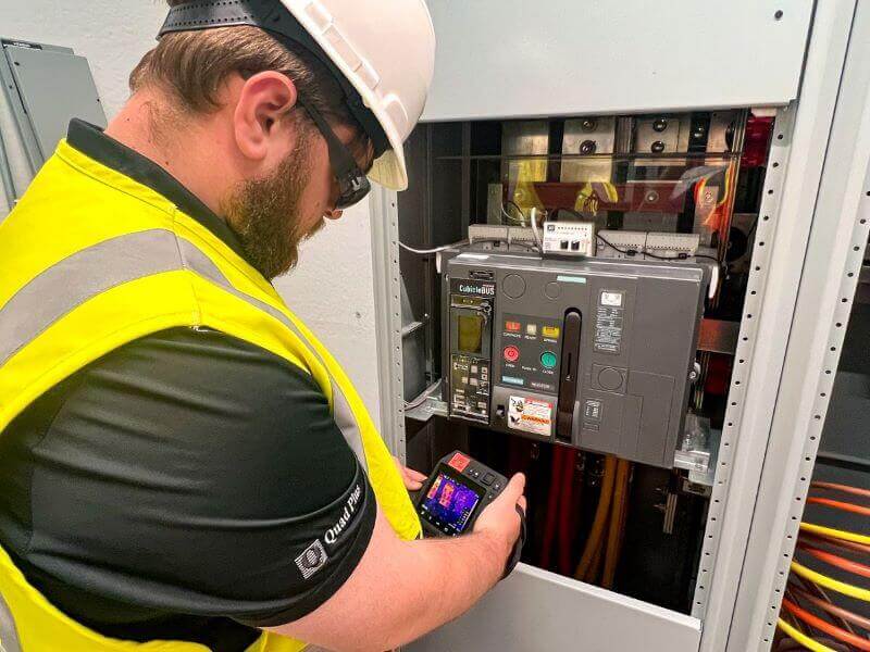 field service engineer inspecting electrical circuit breaker
