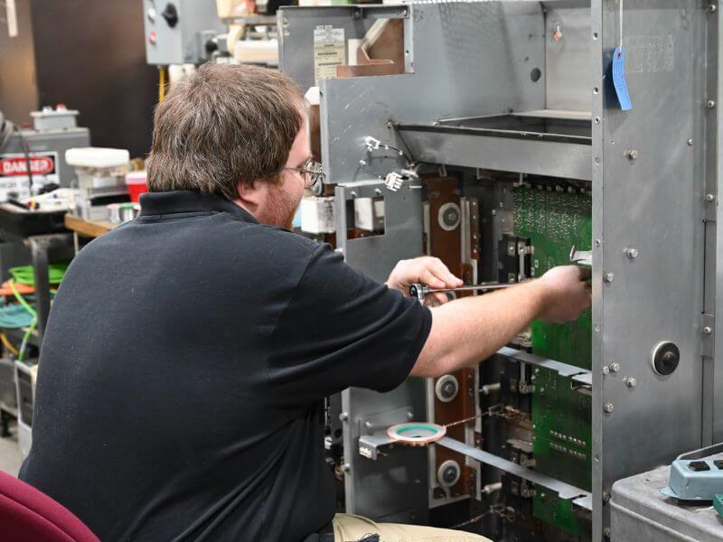 technician performing industrial control repair
