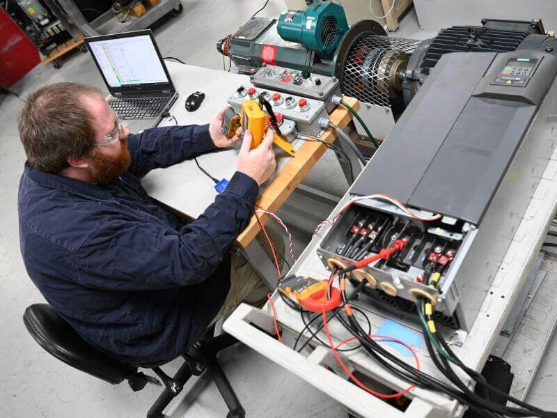 technician tests variable speed drive vs variable frequency drive