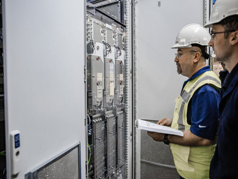 engineers reviewing equipment setup during the commissioning process phase